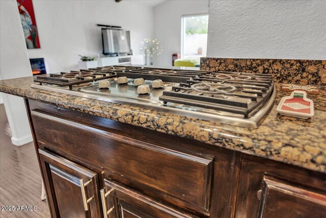 6747 N 12th St, Phoenix, AZ 85014 - interior details with dark brown cabinetry, stainless steel gas cooktop, and wood finished floors