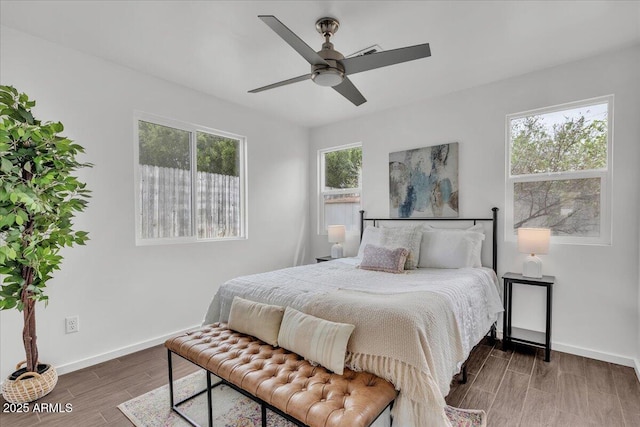 6747 N 12th St, Phoenix, AZ 85014 - bedroom featuring baseboards, wood finished floors, and a ceiling fan