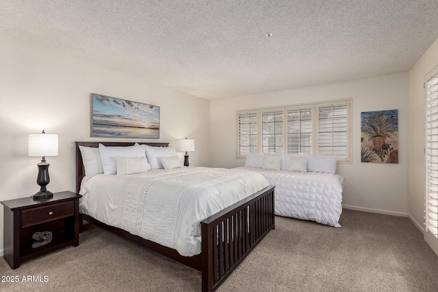 bedroom with a textured ceiling, carpet, and baseboards