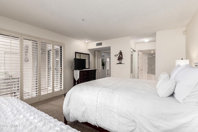 bedroom featuring visible vents, connected bathroom, access to outside, a textured ceiling, and carpet floors