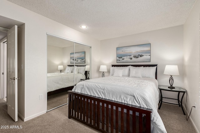 bedroom with carpet, a textured ceiling, baseboards, and a closet