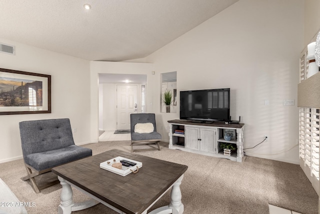 carpeted living area with high vaulted ceiling and visible vents