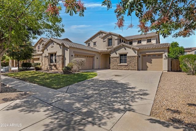 mediterranean / spanish house with a front yard