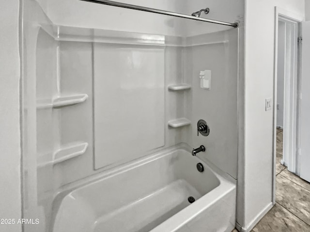 bathroom with washtub / shower combination and tile patterned floors