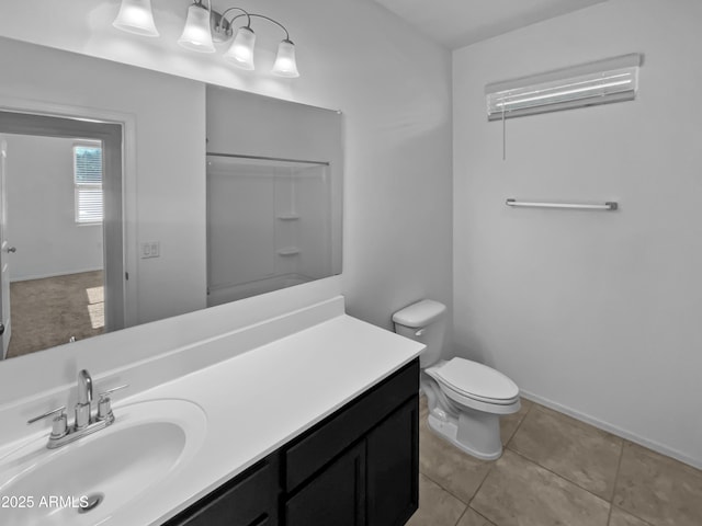 bathroom with tile patterned flooring, vanity, and toilet