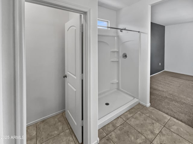 bathroom with tile patterned flooring and a shower