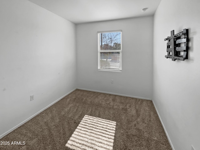 unfurnished room with dark carpet