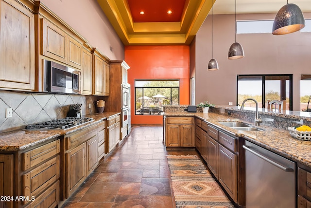 15406 E Cavedale Dr, Scottsdale, AZ 85262 - kitchen featuring appliances with stainless steel finishes, a sink, a high ceiling, stone tile flooring, and decorative backsplash