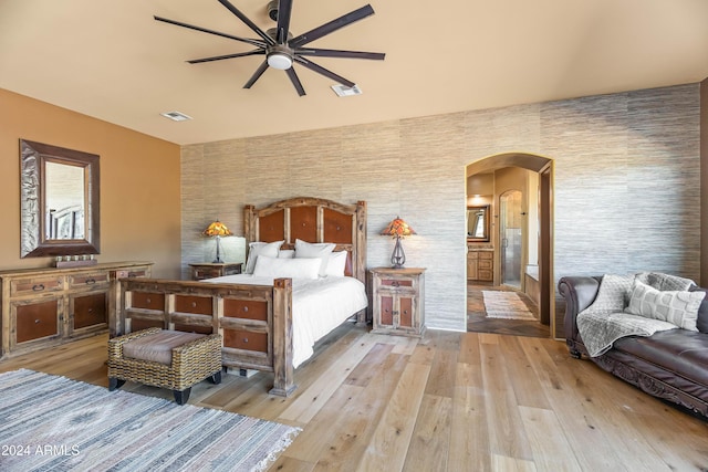 15406 E Cavedale Dr, Scottsdale, AZ 85262 - bedroom with arched walkways and light wood-type flooring