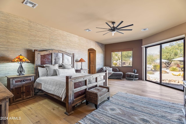 15406 E Cavedale Dr, Scottsdale, AZ 85262 - bedroom with access to exterior, light wood-type flooring, a ceiling fan, and arched walkways