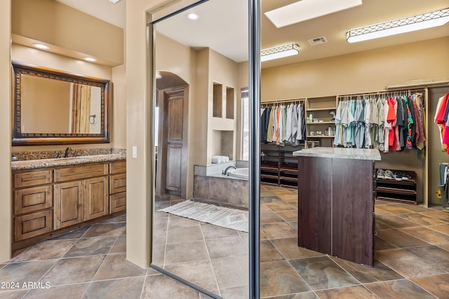 15406 E Cavedale Dr, Scottsdale, AZ 85262 - bathroom featuring a walk in closet, a bath, and vanity