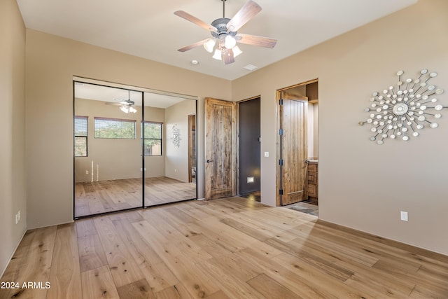 15406 E Cavedale Dr, Scottsdale, AZ 85262 - unfurnished bedroom featuring light wood-type flooring, a closet, and connected bathroom