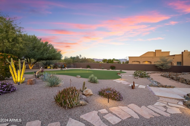 15406 E Cavedale Dr, Scottsdale, AZ 85262 - yard at dusk with a putting green and a fenced backyard