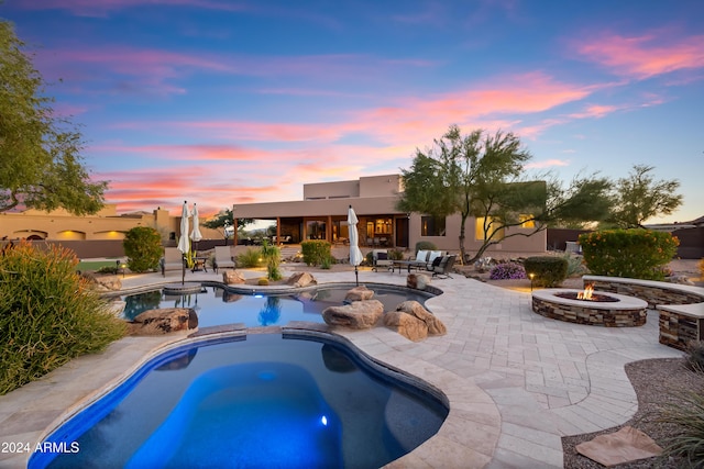 15406 E Cavedale Dr, Scottsdale, AZ 85262 - pool at dusk with an outdoor fire pit, a patio area, and a pool with connected hot tub