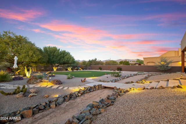 15406 E Cavedale Dr, Scottsdale, AZ 85262 - yard at dusk featuring a putting green and a fenced backyard