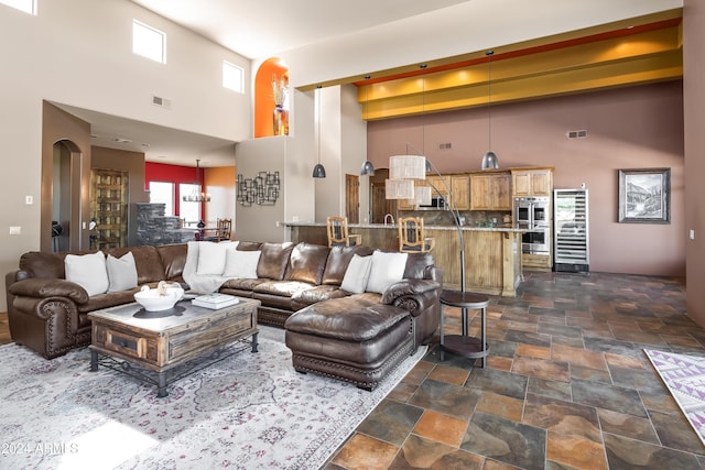 15406 E Cavedale Dr, Scottsdale, AZ 85262 - living area with a high ceiling, dark stone finish flooring, and arched walkways