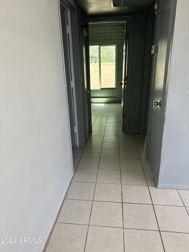 corridor featuring light tile patterned floors