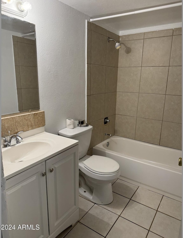 full bathroom featuring tile patterned floors, vanity, toilet, and tiled shower / bath