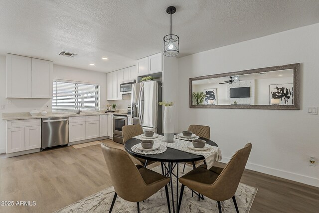 16421 N 34th Ave, Phoenix, AZ 85053 - dining room featuring light wood finished floors, a textured ceiling, recessed lighting, and a ceiling fan