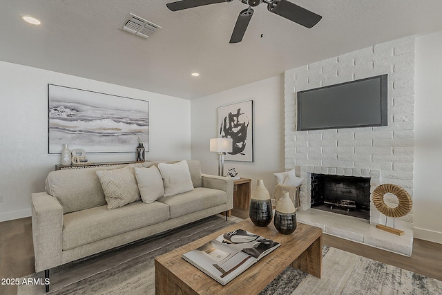 16421 N 34th Ave, Phoenix, AZ 85053 - living room featuring wood finished floors, a ceiling fan, a fireplace, and recessed lighting