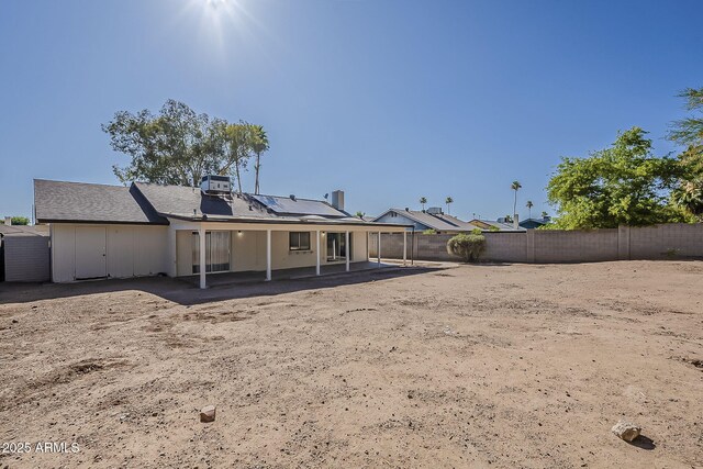 16421 N 34th Ave, Phoenix, AZ 85053 - rear view of property with a patio, a fenced backyard, and solar panels