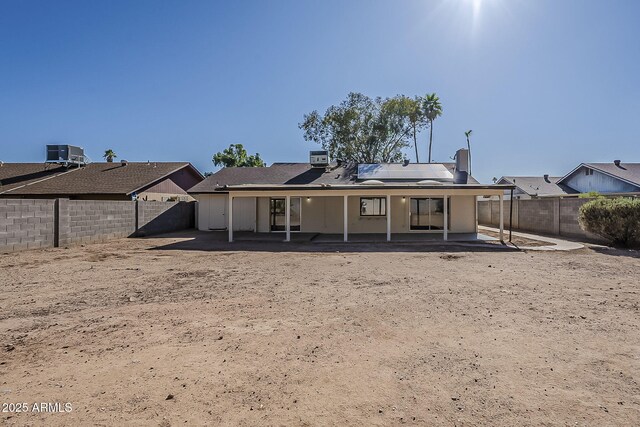 16421 N 34th Ave, Phoenix, AZ 85053 - back of property with solar panels, a fenced backyard, and a patio