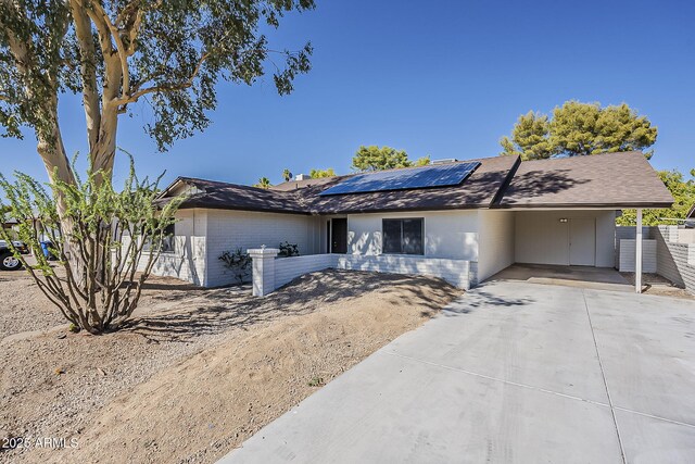 16421 N 34th Ave, Phoenix, AZ 85053 - single story home with an attached carport, driveway, brick siding, and roof mounted solar panels