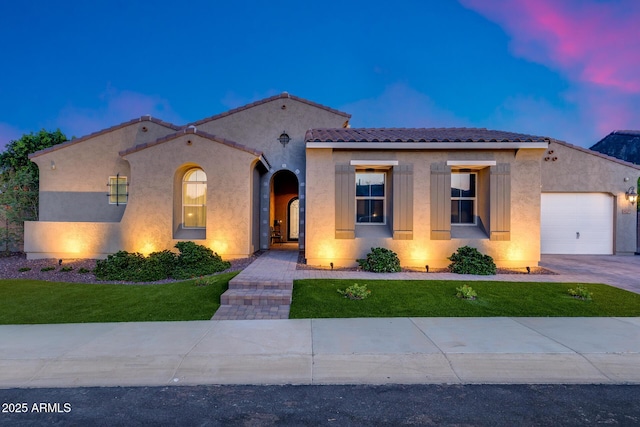 9527 W Whitehorn Way, Peoria, AZ 85383 - mediterranean / spanish-style home with stucco siding, an attached garage, a front lawn, a tiled roof, and driveway