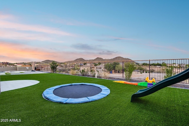 9527 W Whitehorn Way, Peoria, AZ 85383 - playground at dusk featuring a trampoline and a playground