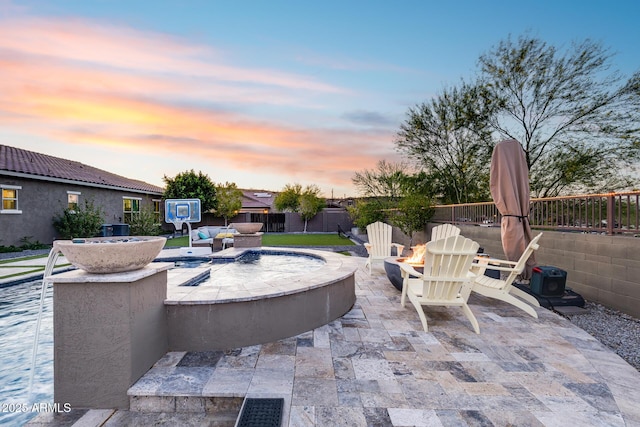 9527 W Whitehorn Way, Peoria, AZ 85383 - patio terrace at dusk with an outdoor fire pit, a fenced backyard, and a patio