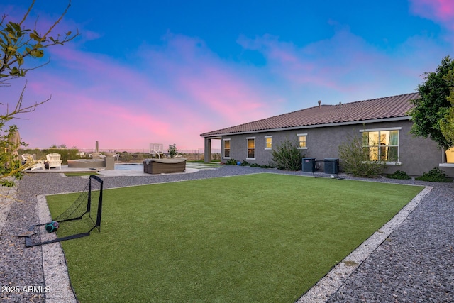 9527 W Whitehorn Way, Peoria, AZ 85383 - yard at dusk featuring central AC unit, a patio area, and a hot tub