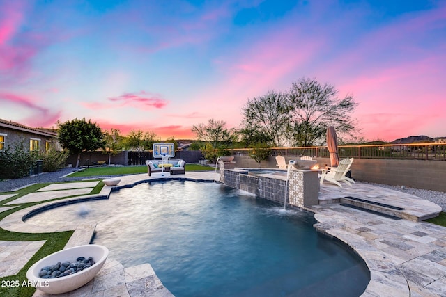 9527 W Whitehorn Way, Peoria, AZ 85383 - pool at dusk with a patio, a fenced backyard, and a fire pit