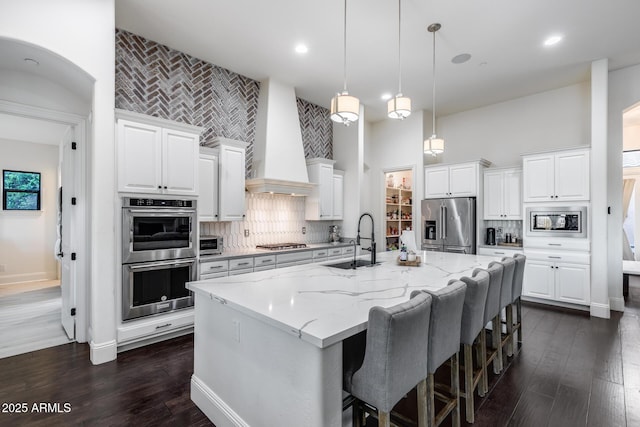9527 W Whitehorn Way, Peoria, AZ 85383 - kitchen with a sink, appliances with stainless steel finishes, a center island with sink, decorative backsplash, and a high ceiling