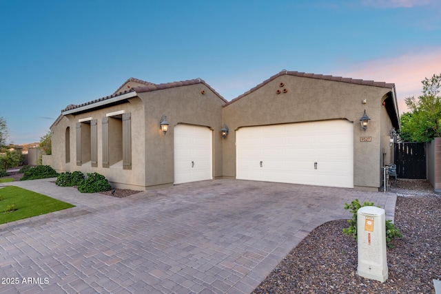 9527 W Whitehorn Way, Peoria, AZ 85383 - mediterranean / spanish house with an attached garage, stucco siding, decorative driveway, and a tiled roof