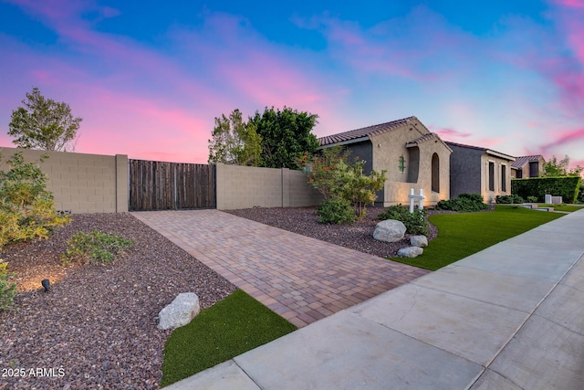 9527 W Whitehorn Way, Peoria, AZ 85383 - property exterior at dusk featuring stucco siding and a gate