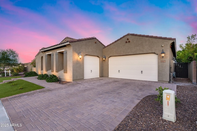 9527 W Whitehorn Way, Peoria, AZ 85383 - mediterranean / spanish home with an attached garage, stucco siding, decorative driveway, and a tile roof