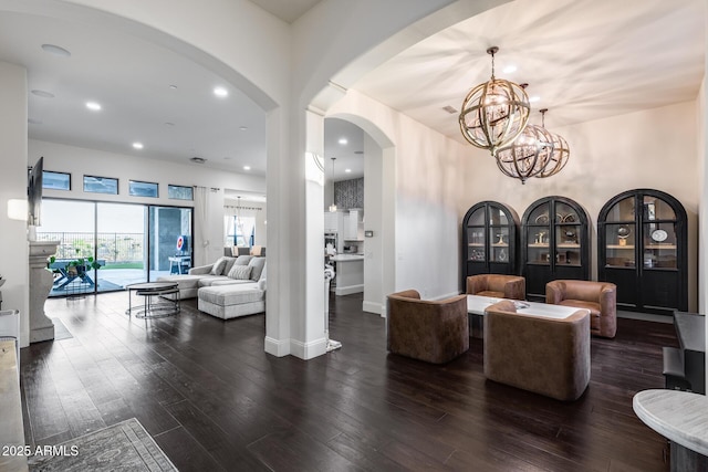 9527 W Whitehorn Way, Peoria, AZ 85383 - dining area featuring arched walkways, a chandelier, dark wood-type flooring, recessed lighting, and baseboards