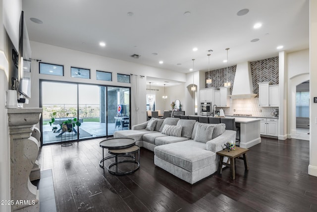 9527 W Whitehorn Way, Peoria, AZ 85383 - living room with recessed lighting, dark wood-style floors, and arched walkways