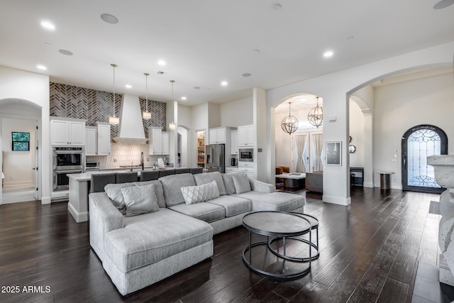 9527 W Whitehorn Way, Peoria, AZ 85383 - living room with recessed lighting, dark wood-style flooring, baseboards, and arched walkways