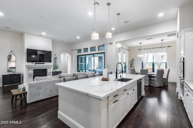 9527 W Whitehorn Way, Peoria, AZ 85383 - kitchen featuring a sink, arched walkways, open floor plan, stainless steel appliances, and dark wood-style floors