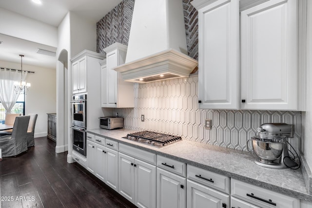 9527 W Whitehorn Way, Peoria, AZ 85383 - kitchen featuring stainless steel appliances, custom range hood, a chandelier, white cabinetry, and decorative backsplash