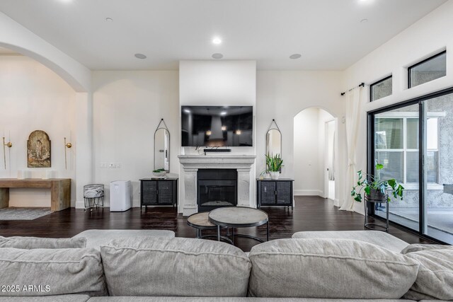 9527 W Whitehorn Way, Peoria, AZ 85383 - living room with arched walkways, dark wood finished floors, baseboards, and recessed lighting