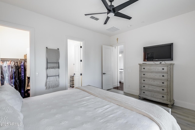 9527 W Whitehorn Way, Peoria, AZ 85383 - bedroom with wood finished floors, a spacious closet, baseboards, a closet, and a ceiling fan