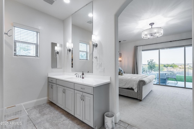 9527 W Whitehorn Way, Peoria, AZ 85383 - ensuite bathroom with vanity, baseboards, plenty of natural light, and tile patterned flooring
