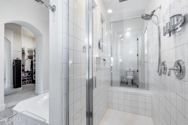 9527 W Whitehorn Way, Peoria, AZ 85383 - bathroom featuring a stall shower, a walk in closet, toilet, and recessed lighting