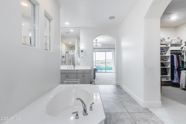 9527 W Whitehorn Way, Peoria, AZ 85383 - full bath featuring a garden tub, a stall shower, vanity, a spacious closet, and baseboards