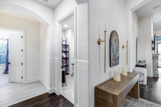 9527 W Whitehorn Way, Peoria, AZ 85383 - hall with wood finished floors, arched walkways, healthy amount of natural light, and baseboards