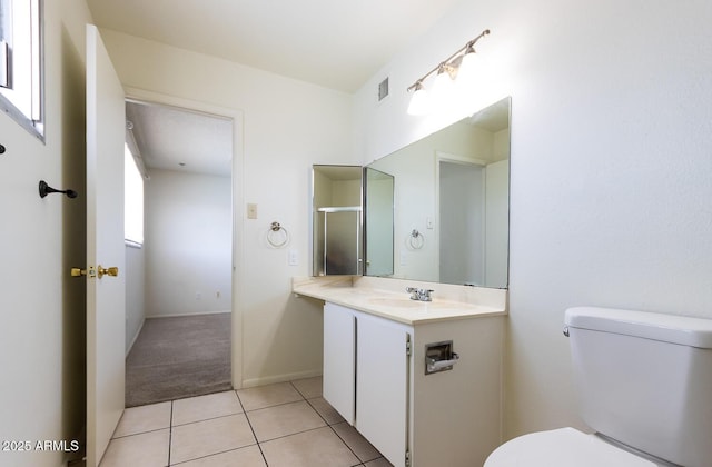 bathroom featuring visible vents, toilet, tile patterned flooring, baseboards, and vanity