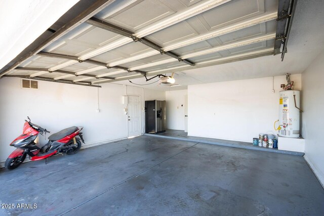 garage featuring visible vents, gas water heater, and a garage door opener