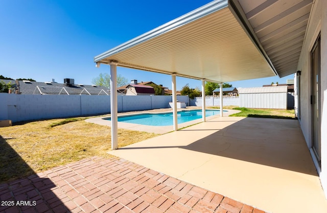 view of swimming pool featuring a patio area, a fenced in pool, a lawn, and a fenced backyard